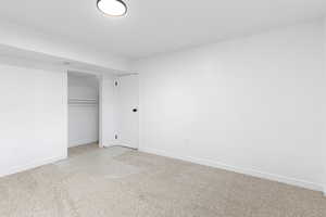 Unfurnished bedroom featuring carpet flooring and a closet