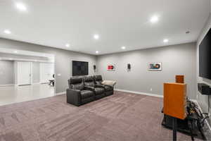 Carpeted living room featuring recessed lighting