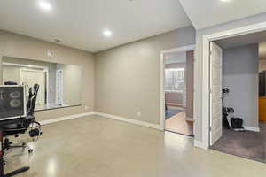 Office area with finished concrete flooring and recessed lighting