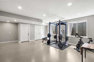 Exercise room featuring concrete floors and recessed lighting