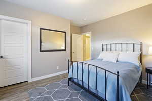 Bedroom with baseboards and dark wood finished floors