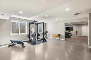 Workout room featuring recessed lighting