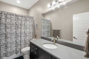 Full bath featuring vanity and recessed lighting