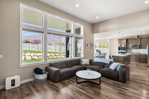 Living room with a mountain view, dark wood finished floors, and recessed lighting