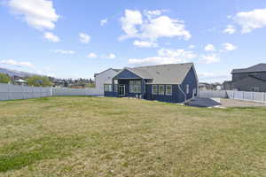 Rear view of house with a patio area, a fenced backyard, and stucco siding