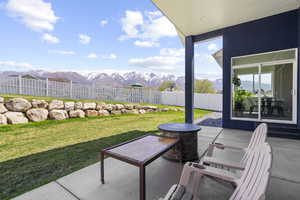 Fenced backyard featuring a mountain view and a patio area