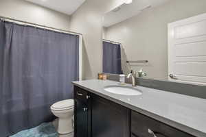 Bathroom with vanity, recessed lighting, and shower / bathtub combination with curtain