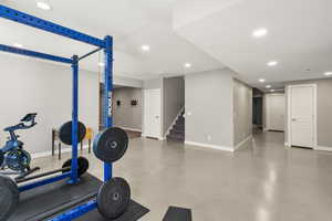 Exercise room with concrete floors and recessed lighting