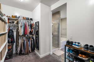 Walk in closet featuring dark carpet