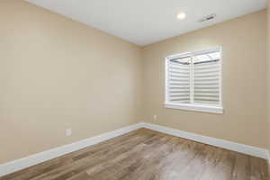 Unfurnished room featuring light wood finished floors and recessed lighting