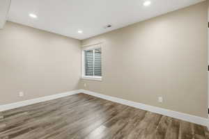 Empty room featuring wood finished floors and recessed lighting