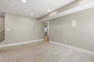 Basement with light carpet and recessed lighting