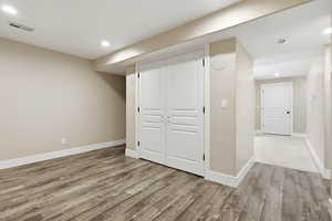 Finished basement with recessed lighting and light wood finished floors