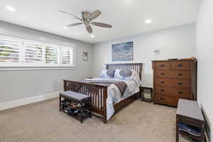 Bedroom featuring ceiling fan, light carpet, and recessed lighting