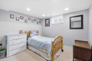 Bedroom with carpet flooring, wainscoting, and recessed lighting
