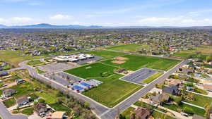 Aerial view of property's location featuring nearby suburban area and a mountain backdrop