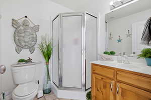 Bathroom featuring a shower stall and vanity