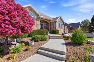 View of front of property with brick siding and covered porch