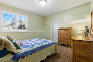 Bedroom featuring dark carpet