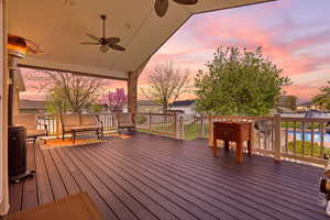 Deck at dusk featuring ceiling fan
