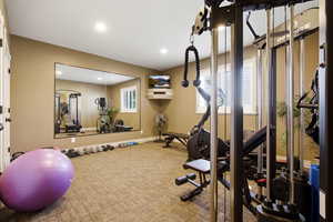 Exercise area featuring recessed lighting
