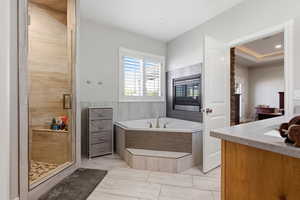 Full bathroom with a stall shower, a bath, vanity, and a sauna