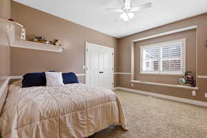 Bedroom with carpet floors and a ceiling fan