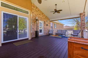 Wooden deck featuring a ceiling fan and outdoor seating
