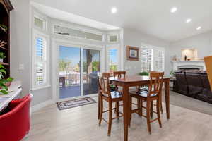 Dining area with a fireplace, recessed lighting, and light wood finished floors
