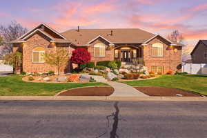 Ranch-style house featuring brick siding, a shingled roof, a gate, and a porch