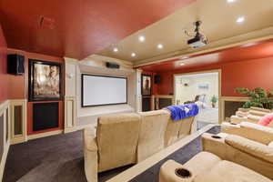 Carpeted home theater room featuring recessed lighting and a tray ceiling