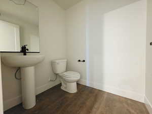 Bathroom featuring dark wood finished floors and toilet