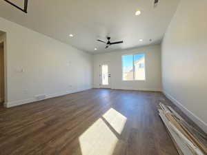 Unfurnished living room with dark wood-type flooring, recessed lighting, and a ceiling fan