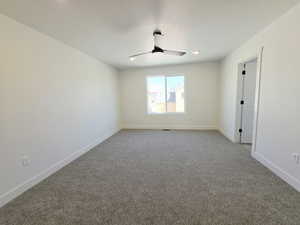 Unfurnished room with carpet flooring and ceiling fan