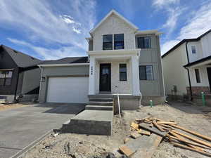 View of front of home with brick siding, concrete driveway, and a garage