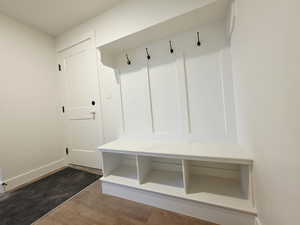 Mudroom with wood finished floors and baseboards