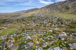 Aerial perspective of suburban area with a mountainous background and property parcel outlined