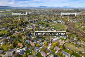 Aerial view of property's location featuring nearby suburban area, mountains, and property boundaries highlighted