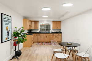 Kitchen with dark countertops and light wood-style flooring