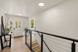 Foyer entrance featuring light wood-type flooring and a textured ceiling