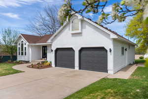 View of front of property featuring brick siding, driveway, a garage, and a front yard