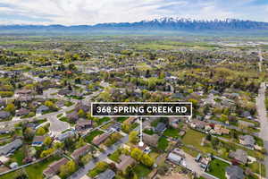 Aerial view of residential area with a mountain backdrop and property boundaries highlighted
