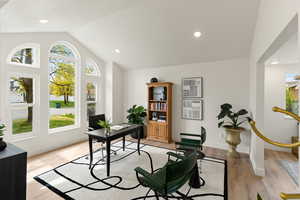 Office space with light wood-style floors, plenty of natural light, vaulted ceiling, and recessed lighting