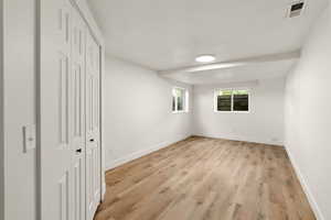 Unfurnished bedroom with a closet and light wood-style floors