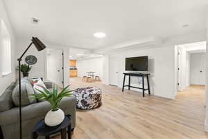 Living area with light wood-type flooring and baseboards