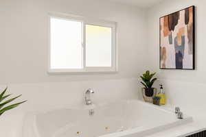 Full bath with a tub with jets