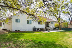 Rear view of house with a patio and an outdoor hangout area