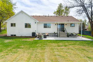 Rear view of house with a patio and roof with shingles