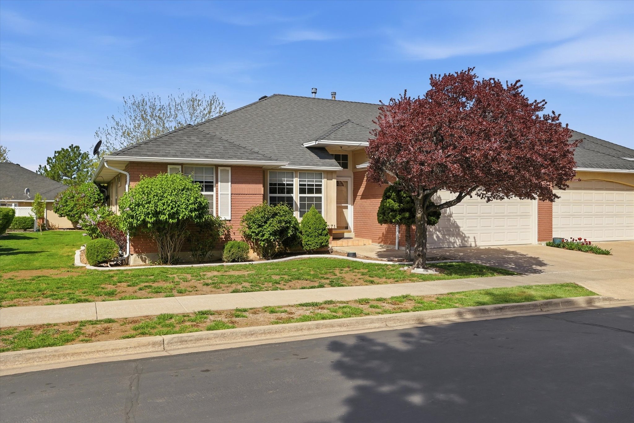 View of front of home with driveway, a front yard, a garage