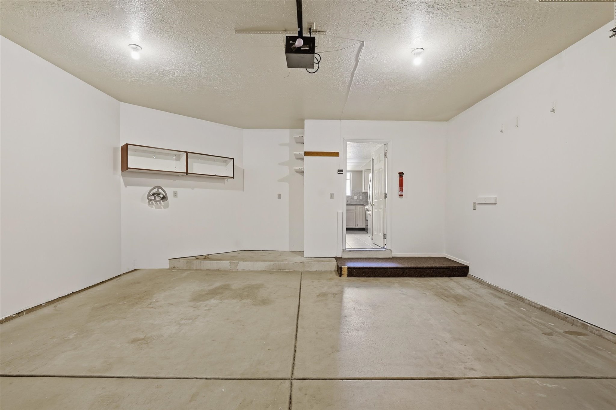 Garage featuring a garage door opener